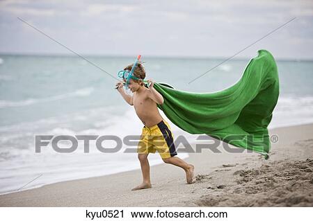 Boy wearing a scuba mask and running on the beach View Large Photo Image Stock Image - Boy wearing a scuba mask and running on the beach. Fotosearch
