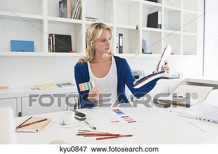 Stock Photo - Businesswoman choosing color swatches. Fotosearch