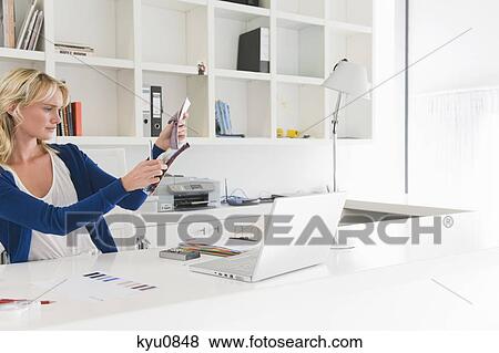 Stock Photo - Businesswoman choosing color swatches. Fotosearch