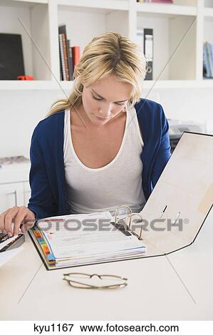 Stock Photo - Businesswoman choosing color swatches. Fotosearch