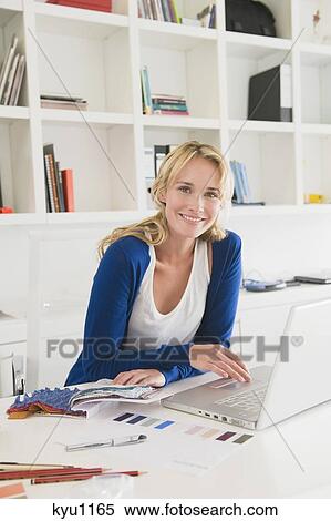 Stock Photography - Businesswoman choosing color swatches. Fotosearch