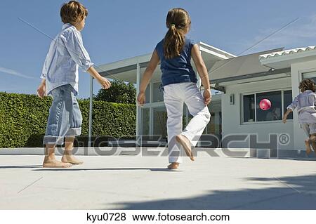 Children playing with a ball View Large Photo Image Stock Photo - Children playing with a ball. Fotosearch