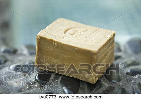 Stock Image - Close-up of a bar of soap on a poolside. Fotosearch