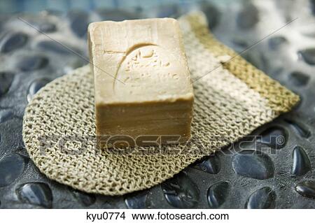 Picture - Close-up of a bar of soap on a washcloth. Fotosearch