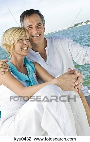 Close-up of a couple smiling View Large Photo Image Stock Image - Close-up of a couple smiling. Fotosearch