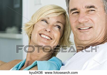 Close-up of a couple smiling View Large Photo Image Stock Photograph - Close-up of a couple smiling. Fotosearch