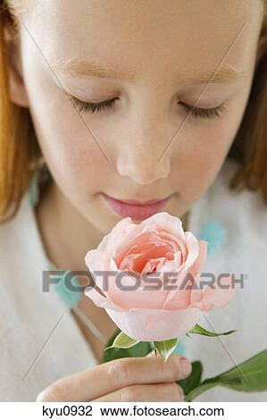 Close-up of a flower girl smelling a flower View Large Photo Image Stock Image - Close-up of a flower girl smelling a flower. Fotosearch