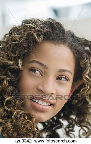 Close-up of a girl smiling View Large Photo Image Stock Image - Close-up of a girl smiling. Fotosearch
