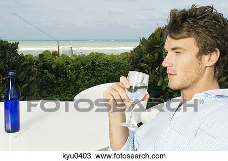 Stock Image - Close-up of a man drinking water. Fotosearch