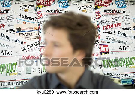 Close-up of a mid adult man in front of a newsstand View Large Photo Image Stock Image - Close-up of a mid adult man in front of a newsstand. Fotosearch