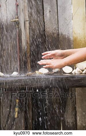 Close-up of a person's hands under a beach shower View Large Photo Image Stock Image - Close-up of a person's hands under a beach shower. Fotosearch