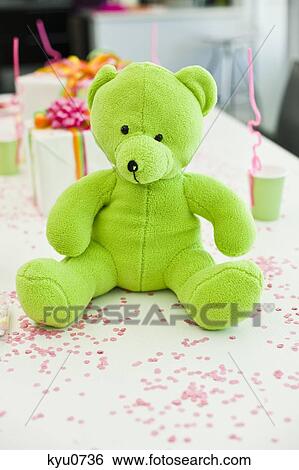Stock Photograph - Close-up of a teddy bear with birthday presents on a table. Fotosearch