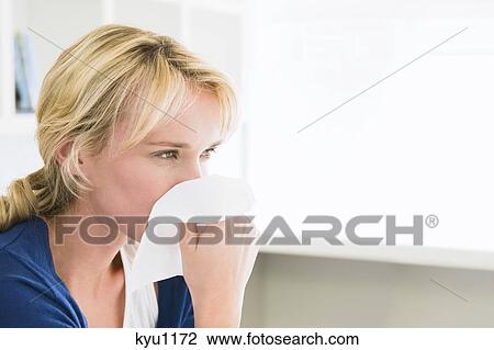Close-up of a woman blowing her nose with a handkerchief View Large Photo Image Stock Image - Close-up of a woman blowing her nose with a handkerchief. Fotosearch