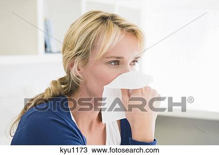 Close-up of a woman blowing her nose with a handkerchief View Large Photo Image Stock Image - Close-up of a woman blowing her nose with a handkerchief. Fotosearch