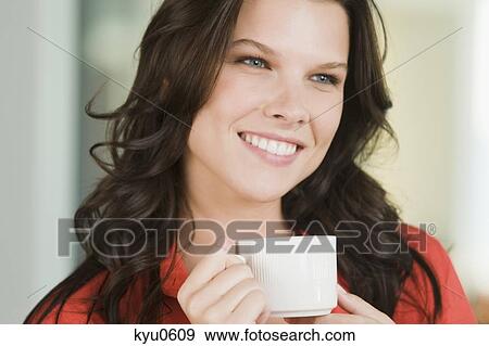 Stock Photo - Close-up of a woman drinking coffee. Fotosearch