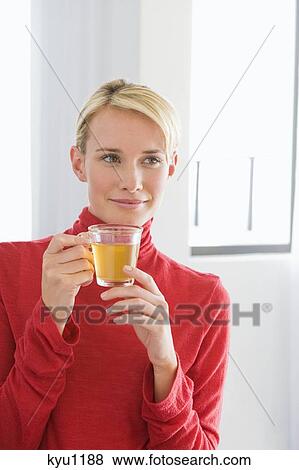 Close-up of a woman holding a cup of tea View Large Photo Image Stock Photo - Close-up of a woman holding a cup of tea. Fotosearch