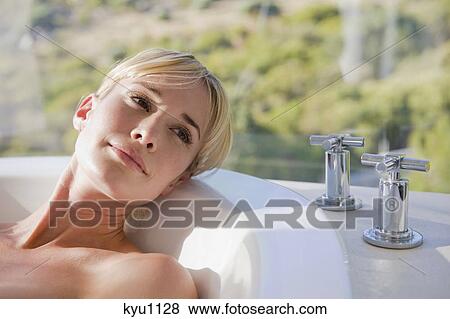 Stock Photo - Close-up of a woman in a bathtub. Fotosearch