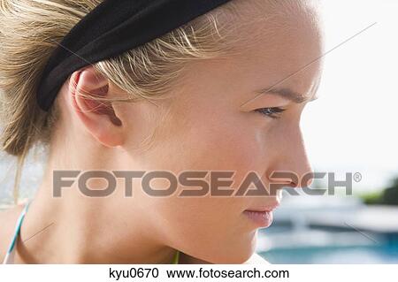 Close-up of a woman looking away View Large Photo Image Stock Image - Close-up of a woman looking away. Fotosearch