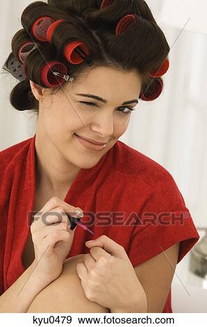Close-up of a woman painting finger nails View Large Photo Image Stock Photo - Close-up of a woman painting finger nails. Fotosearch