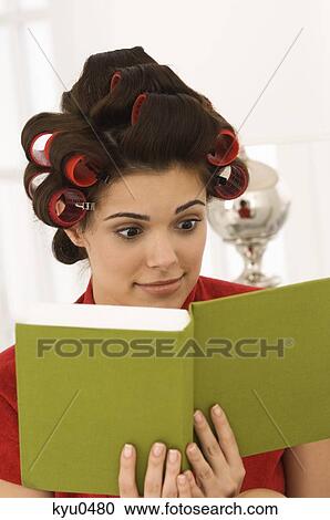 Close-up of a woman reading a book View Large Photo Image Stock Image - Close-up of a woman reading a book. Fotosearch