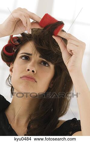 Close-up of a woman removing hair curlers View Large Photo Image Picture - Close-up of a woman removing hair curlers. Fotosearch