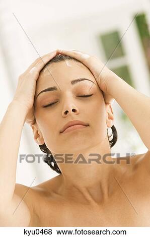 Close-up of a woman shampooing her hair View Large Photo Image Stock Photo - Close-up of a woman shampooing her hair. Fotosearch