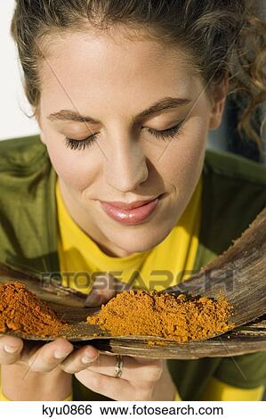 Close-up of a woman smelling spices View Large Photo Image Stock Photograph - Close-up of a woman smelling spices. Fotosearch