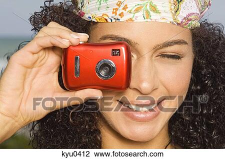 Close-up of a woman taking a picture with a digital camera View Large Photo Image Stock Image - Close-up of a woman taking a picture with a digital camera. Fotosearch