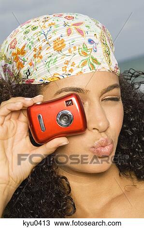 Close-up of a woman taking a picture with a digital camera View Large Photo Image Stock Image - Close-up of a woman taking a picture with a digital camera. Fotosearch