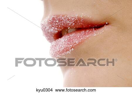 Picture - Close-up of a woman's lips covered with sugar. Fotosearch