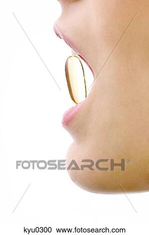 Close-up of a woman's mouth with a capsule between her teeth View Large Photo Image Stock Image - Close-up of a woman's mouth with a capsule between her teeth. Fotosearch