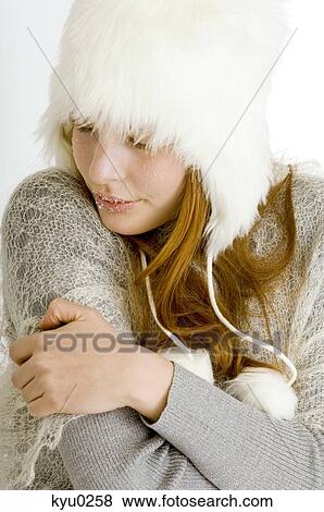 Close-up of a young woman shivering with cold View Large Photo Image Stock Photo - Close-up of a young woman shivering with cold. Fotosearch
