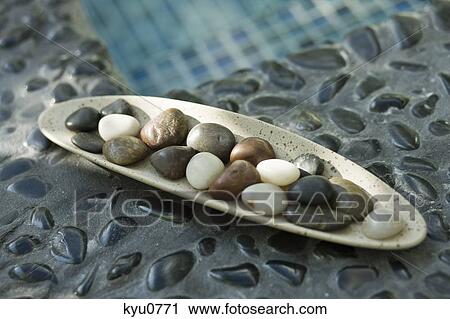 Stock Image - Close-up of pebbles in a tray. Fotosearch