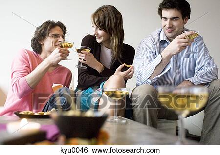 Couple and man drinking champagne View Large Photo Image Stock Photograph - Couple and man drinking champagne. Fotosearch