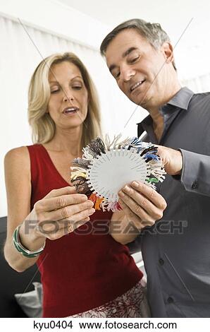 Couple choosing color from a color swatch View Large Photo Image Picture - Couple choosing color from a color swatch. Fotosearch