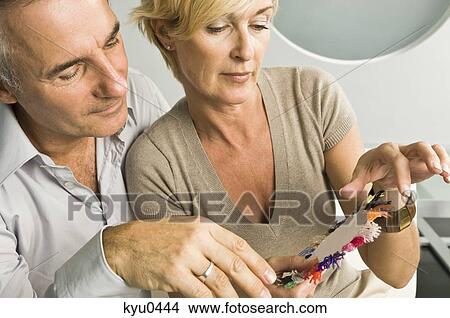 Picture - Couple choosing color from a color swatch. Fotosearch