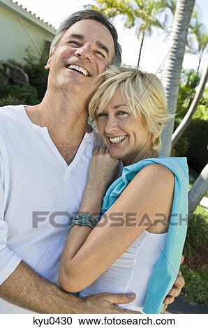 Stock Image - Couple embracing each other and smiling. Fotosearch