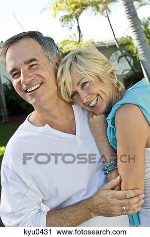 Stock Image - Couple embracing each other and smiling. Fotosearch