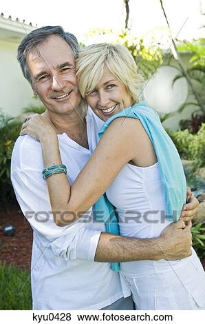 Stock Photo - Couple embracing each other and smiling. Fotosearch