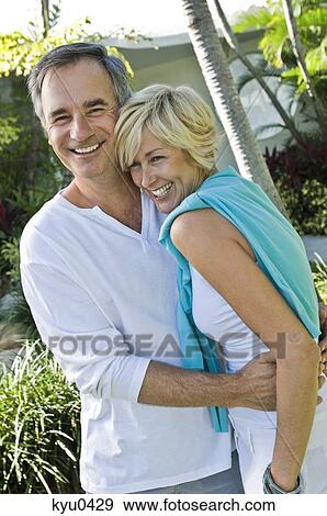 Stock Photo - Couple embracing each other and smiling. Fotosearch