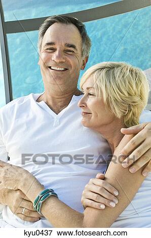 Stock Photo - Couple embracing each other and smiling. Fotosearch