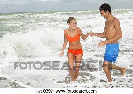 Couple enjoying on the beach View Large Photo Image Stock Photo - Couple enjoying on the beach. Fotosearch