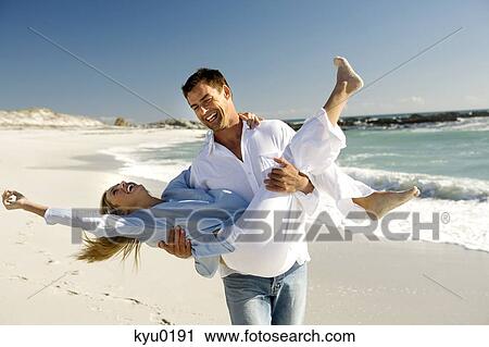 Couple on the beach View Large Photo Image Stock Image - Couple on the beach. Fotosearch