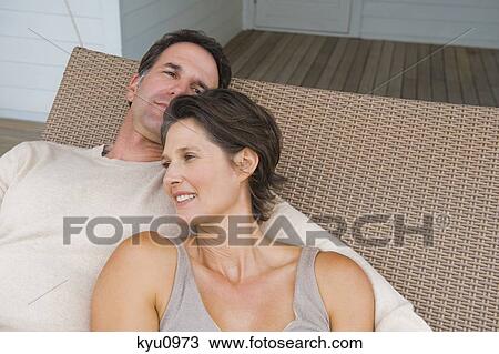 Stock Image - Couple resting on a porch swing. Fotosearch