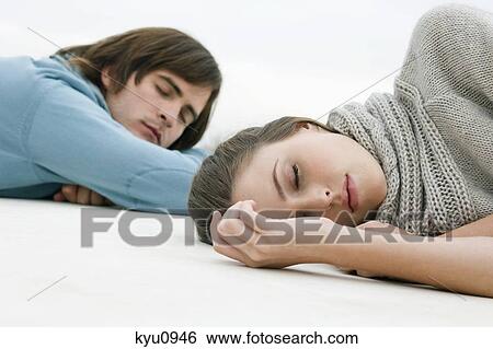Couple resting on the floor View Large Photo Image Stock Photograph - Couple resting on the floor. Fotosearch