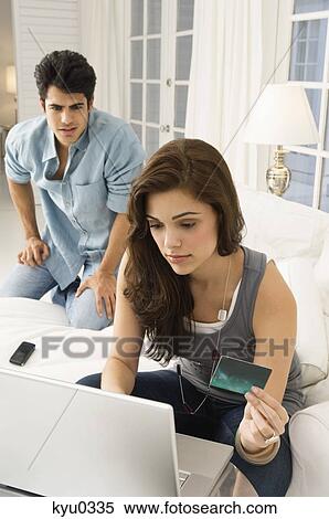 Stock Photography - Couple shopping online with a credit card. Fotosearch