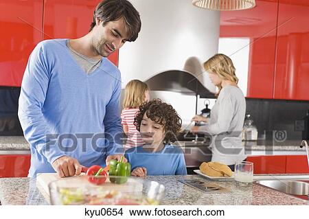 Picture - Family cooking food in the kitchen. Fotosearch