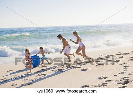 Stock Image - Family enjoying vacations on the beach. Fotosearch