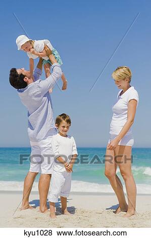 Family enjoying vacations on the beach View Large Photo Image Stock Photo - Family enjoying vacations on the beach. Fotosearch
