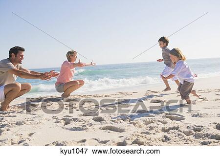 Stock Photo - Family enjoying vacations on the beach. Fotosearch